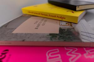 a stack of books sitting on top of a table at Hostal Hera in Barcelona