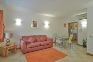 a living room with a couch and a table at Casa Monte Cristo Apartments - Orange in Lagos