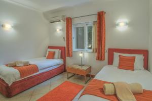 a bedroom with two beds and a window at Casa Monte Cristo Apartments - Orange in Lagos +26 photos