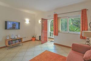 a living room with a couch and a window at Casa Monte Cristo Apartments - Orange in Lagos