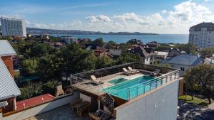 a house with a swimming pool on top of it at Guest House Lima in Gelendzhik