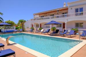 a swimming pool in front of a villa at Casa Monte Cristo Apartments - Orange in Lagos