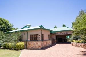 a building with a brick driveway in front of it at Downstream in Dullstroom