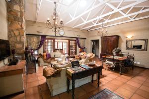 a large living room with a couch and a table at Downstream in Dullstroom