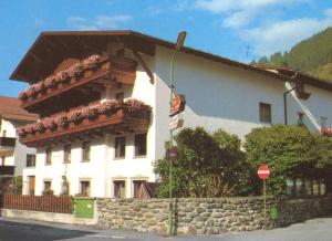 a large white building with flowers on the balcony at Gästehaus Maschler in Sankt Anton am Arlberg