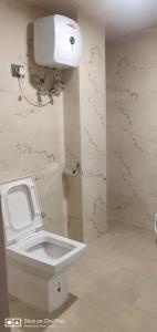 a bathroom with a white toilet and a sink at Hotel Namgyal House in Gangtok