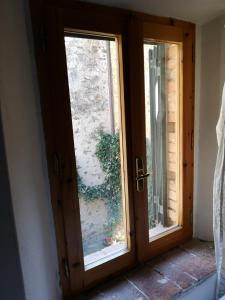 
a window in a small room with a wooden door at Antico Borgo di Torri in Sovicille
