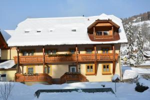 a building with snow on top of it at Haus Ingrid in Sankt Georgen ob Murau