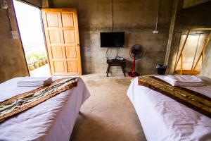 Postel nebo postele na pokoji v ubytování My Place Mae Salong