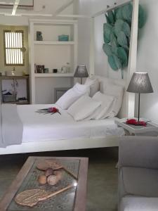 a bedroom with a white bed and a table at South House-Weligama in Weligama +95 photos