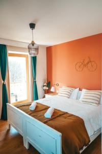 a bedroom with a large bed with a bike on the wall at Casa di Franz in Vigo di Fassa