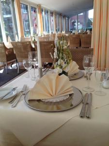 une table avec une plaque recouverte d'une serviette. dans l'établissement Parkhotel Kevelaer, à Kevelaer