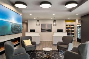 a waiting room at a hospital with chairs and a fireplace at Microtel Inn & Suites by Wyndham Antigonish in Antigonish