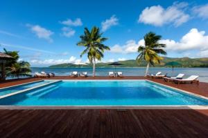 a swimming pool with a view of the ocean at Le Vasseur La Buse Eco Resort in Baie Sainte Anne