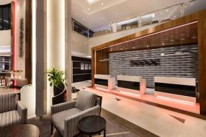 a lobby with two chairs and a fireplace at Ramada by Wyndham Dubai Barsha Heights in Dubai