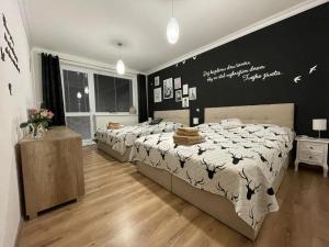 A bed or beds in a room at Style Apartment Telgart