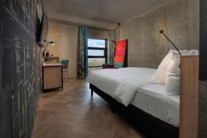Postel nebo postele na pokoji v ubytování Inntel Hotels Amsterdam Landmark