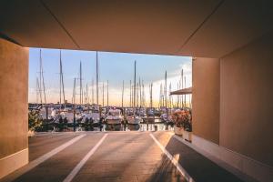 a view from a balcony of a marina with boats at Mosella Suite Hotel in Sottomarina