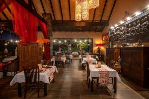 a restaurant with tables and chairs in a room at The Zarafa in Hazyview