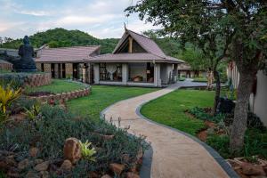 a house with a statue and a walkway at The Zarafa in Hazyview