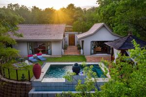 a house with a swimming pool in the yard at The Zarafa in Hazyview