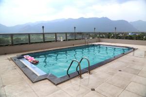 a swimming pool on the roof of a building at Hotel Western Gatz in Theni