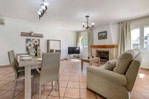 a living room with a table and a dining room at Villa Alaska - PlusHolidays in Calpe