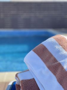 a white towel sitting on top of a blue towel at Grand Tourist Hotel in Muscat