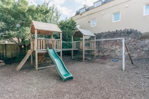 a playground with a slide and a gazebo at The Bear & Swan in Bristol