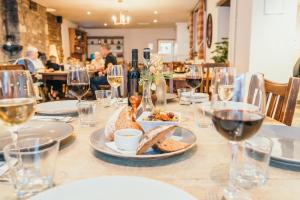 a table with plates of food and glasses of wine at The Bear & Swan in Bristol