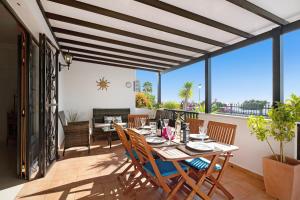 a dining room with a table and chairs on a patio at Villa Carolina in Tías