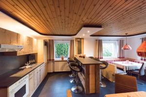a kitchen with a island in the middle of it at Haus Maria Larcher in Bach