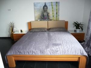 ein Bett in einem Schlafzimmer mit einer Statue an der Wand in der Unterkunft Ferienwohnung Germersheim in Germersheim