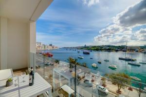 a balcony with a view of a harbor at Superlative Apartment with Valletta and Harbour Views in Sliema