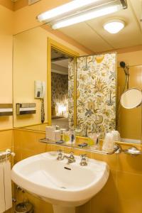 a bathroom with a sink and a mirror at Hotel Villa La Principessa in Lucca