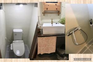 a small bathroom with a sink and a toilet at Travelers House おーさんてぃん青空舎 in Taketomi