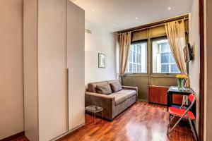 a living room with a couch and a window at M&L Apartments - Ardesia Colosseo in Rome
