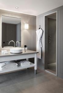 a bathroom with a sink and a mirror at Hôtel Plage Palace & Spa in Palavas-les-Flots