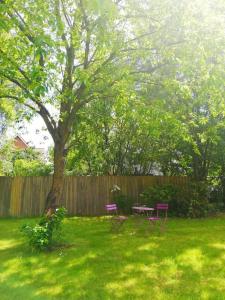 a backyard with a picnic table and a tree at 4 minute walk to LEGO House - n4 in Billund