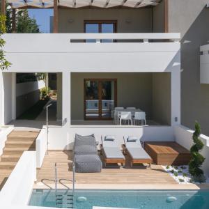 a house with a swimming pool and a patio at De Light Boutique Villas I II & III - Fine retreat, by ThinkVilla in Atsipopoulo
