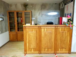 a kitchen with wooden cabinets in a room at Happy Inn Hotel Alpiyskiy in Saint Petersburg