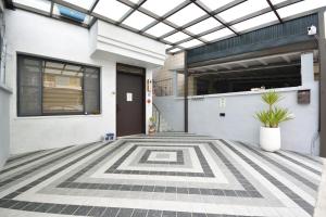 a house with a geometric tile floor at Full house in Taitung City
