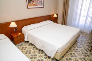 Postel nebo postele na pokoji v ubytování Hotel Pietra di Luna