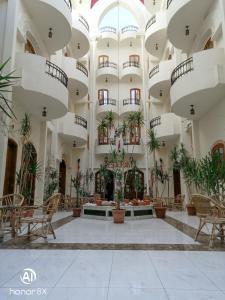 un hall d'un bâtiment avec des plantes en pot dans l'établissement Al Hambra Hotel, à Louxor