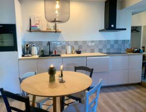 a kitchen with a wooden table with two candles on it at Appartement Le Ponteil in Les Deux Alpes