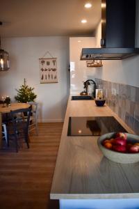 a kitchen with a bowl of fruit on a counter at Appartement Le Ponteil in Les Deux Alpes +7 photos