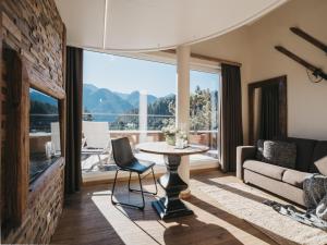 a living room with a table and a couch at VAYA Terrazena Serfaus in Serfaus