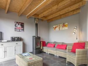 a living room with a couch and a wood stove at Gîte Nort-sur-Erdre, 3 pièces, 5 personnes - FR-1-306-1145 in Nort-sur-Erdre