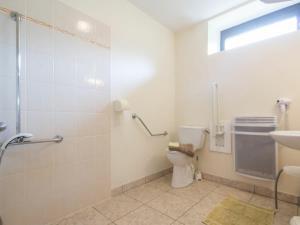 a bathroom with a shower and a toilet and a sink at Gîte Guémené-Penfao, 4 pièces, 7 personnes - FR-1-306-1130 in Guéméné-Penfao