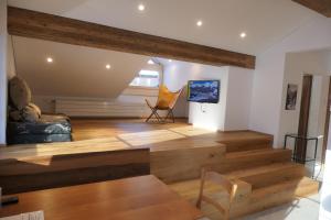 a living room with wooden floors and a staircase at Chalet Valeria in Saas-Fee